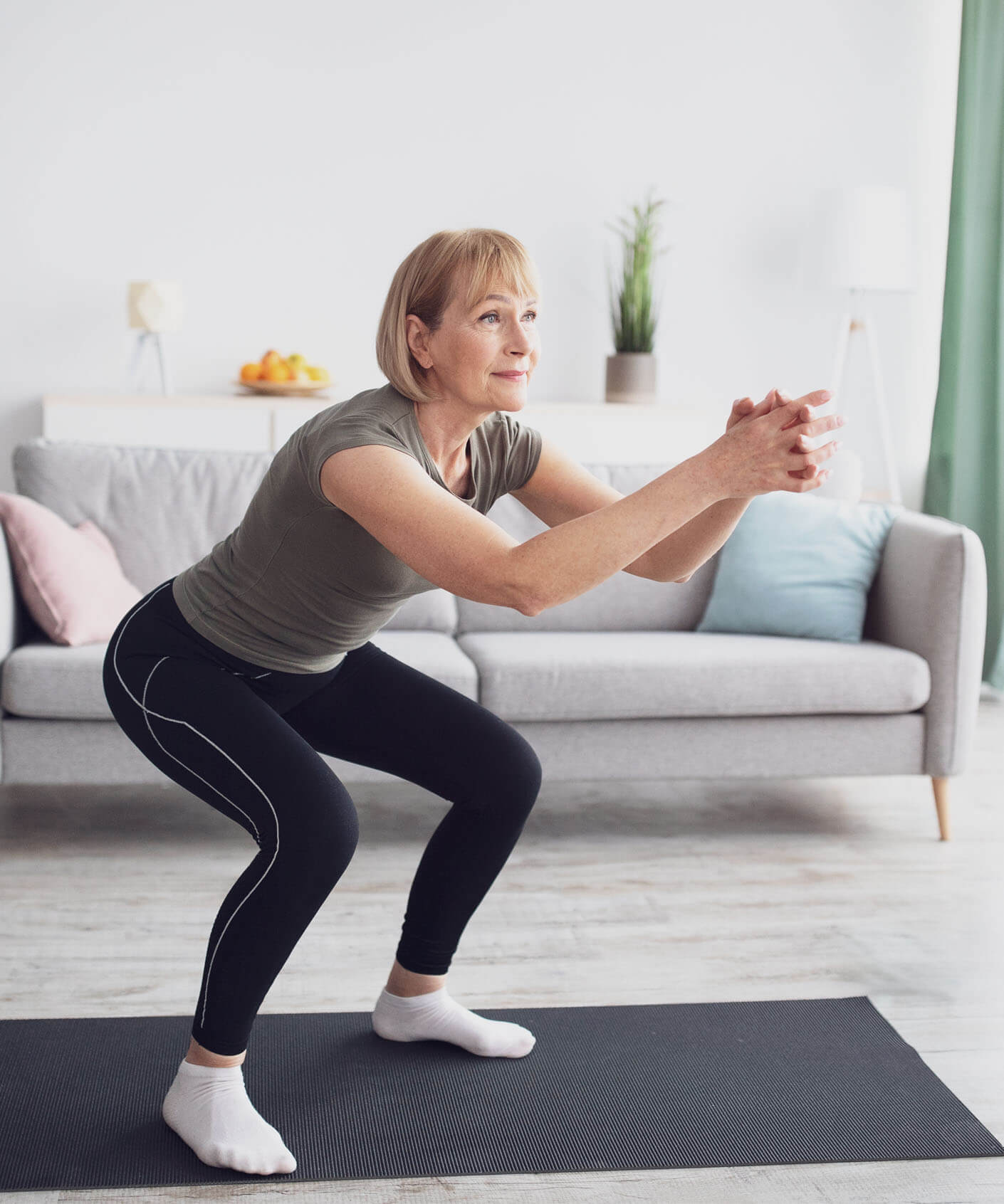 older women doing a squat