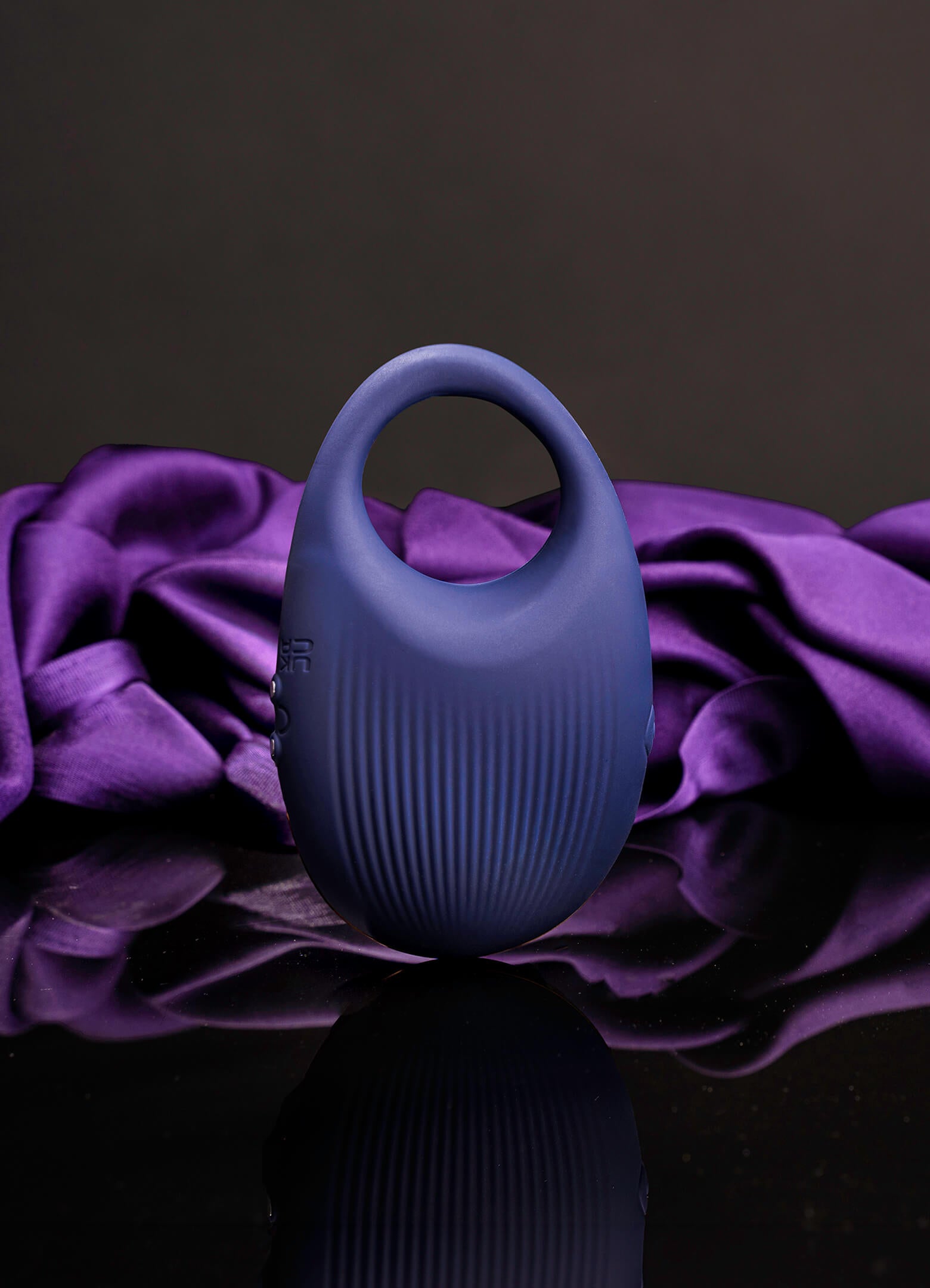 Vibrating navy silicone cock ring with a ribbed surface.