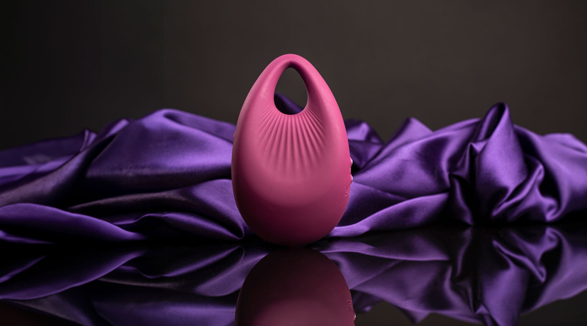 Pear shaped burgundy finger vibrator.