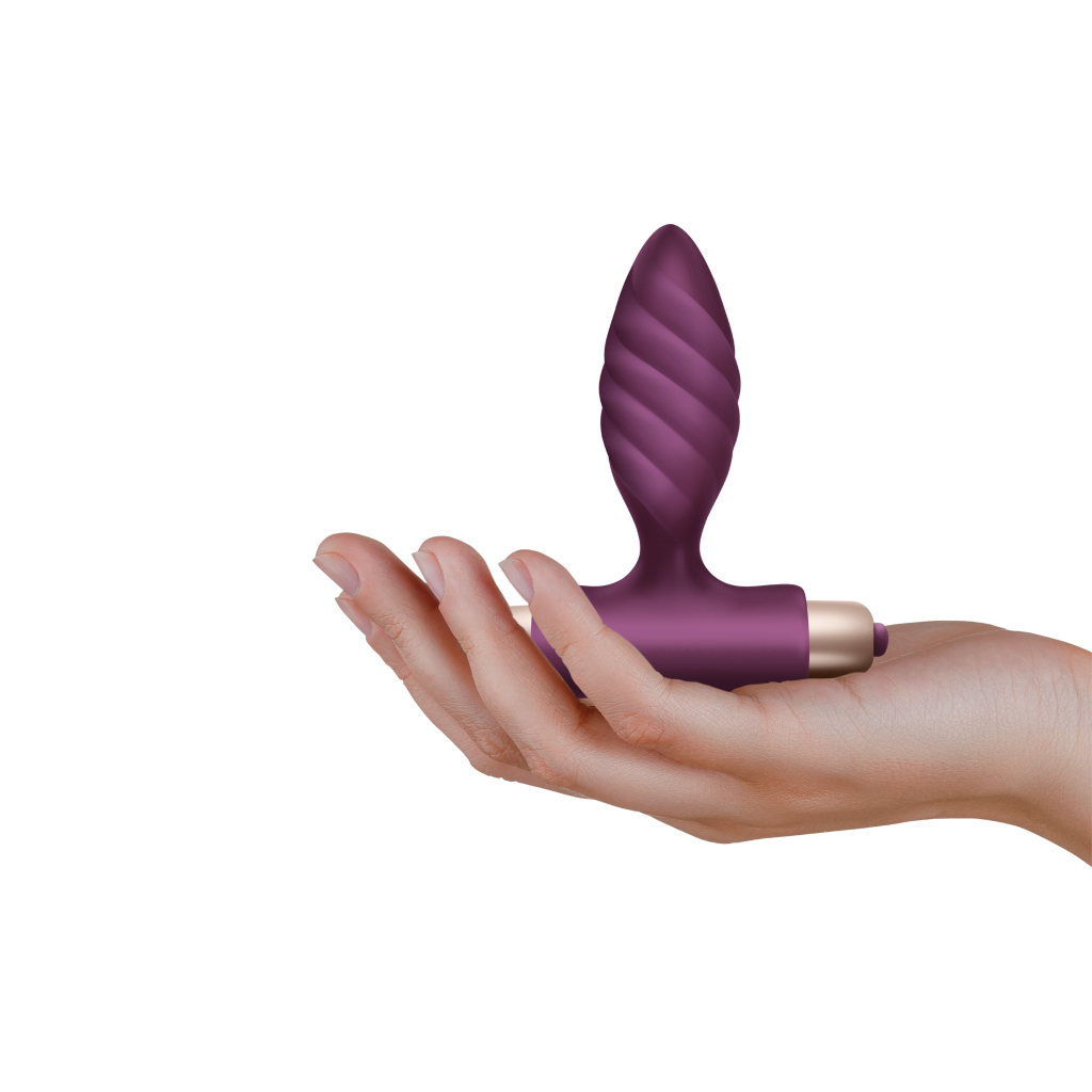 Purple and gold Oryx vibrating toy held in a hand on a white background