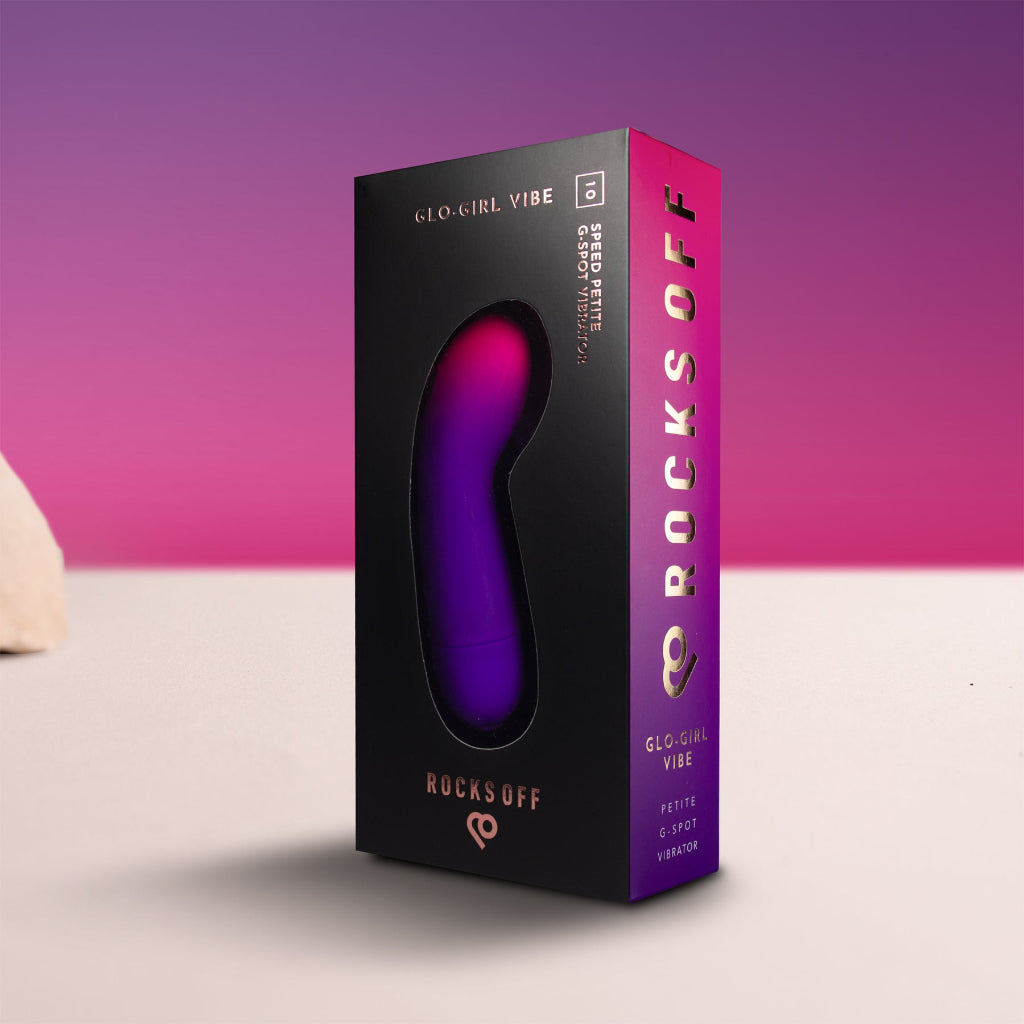 Purple and black packaging of a Glo-Girl Vibe on a pink and purple gradient background. Simple and elegant