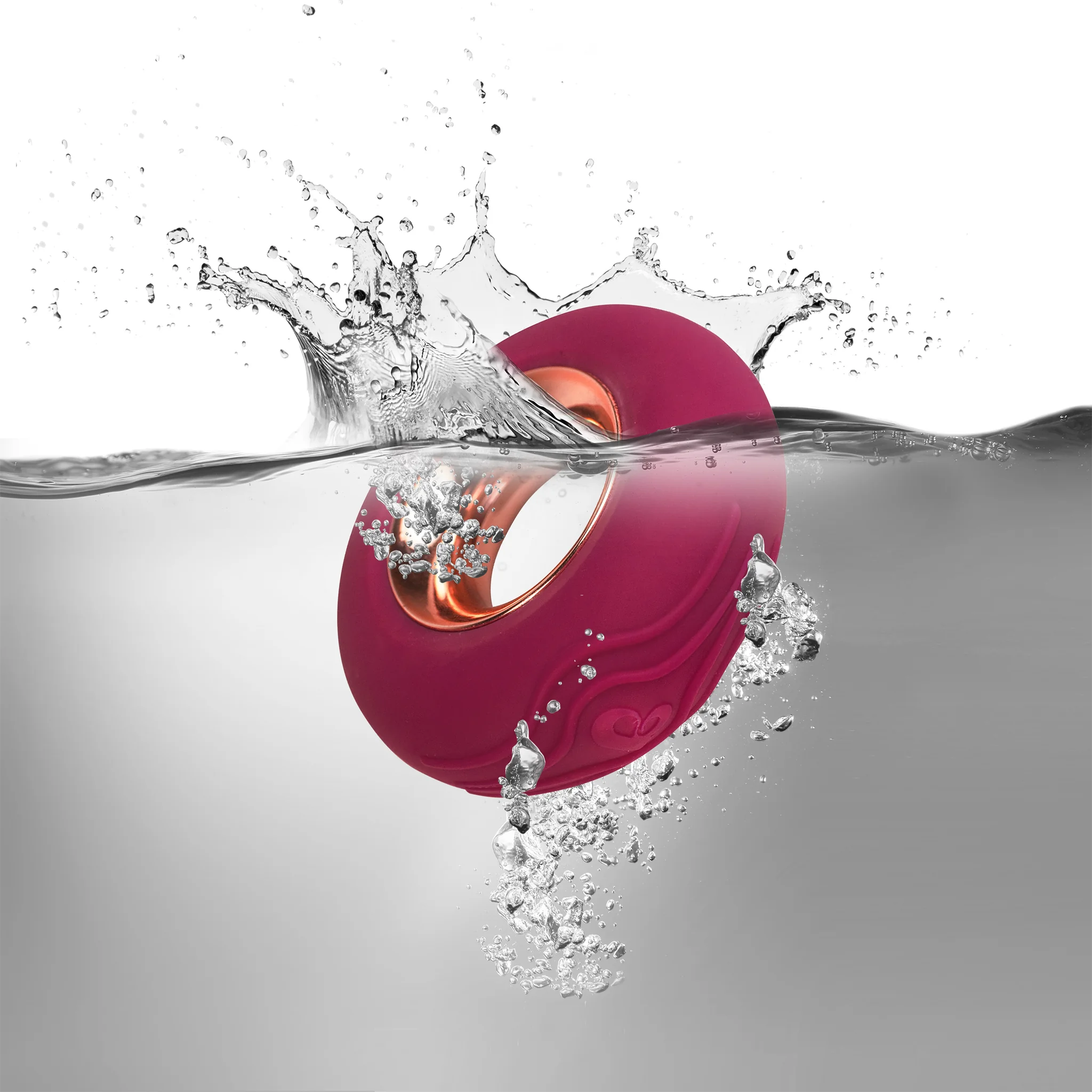Magenta massager with water splash and droplets around it