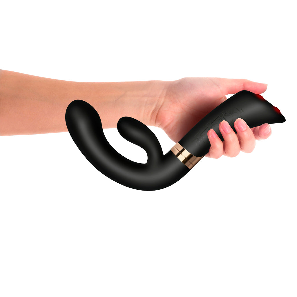 Hand holding the FUZION Enigma demonstrating ergonomic handle grip and thumb controls