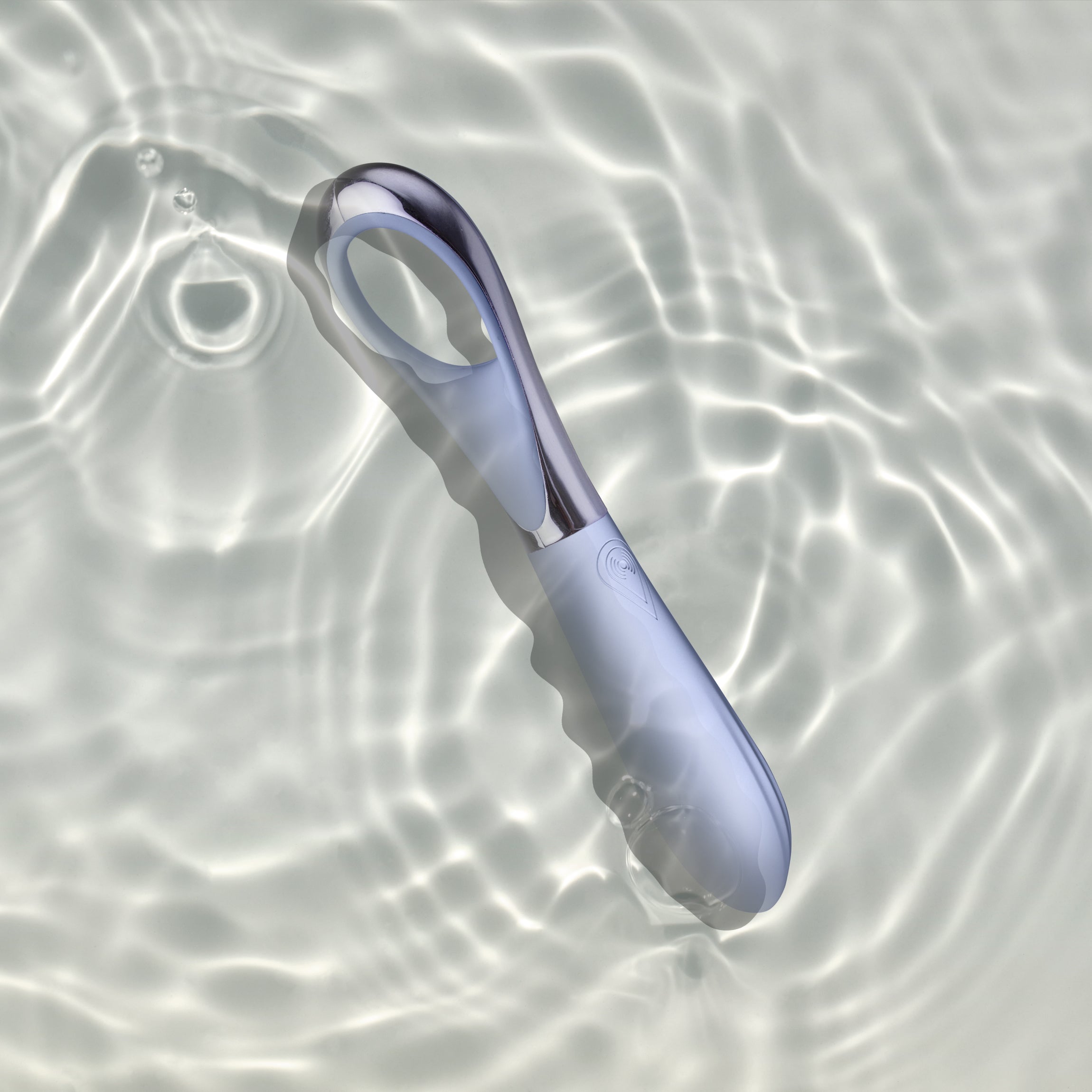 Niya Finger Vibe with a light blue silicone body and a metallic silver handle, shown in water to show water proof design
