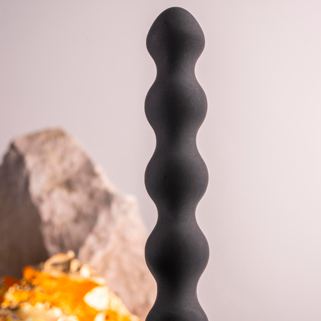 Black wavy silicone vibrating anal toy with rounded ridges