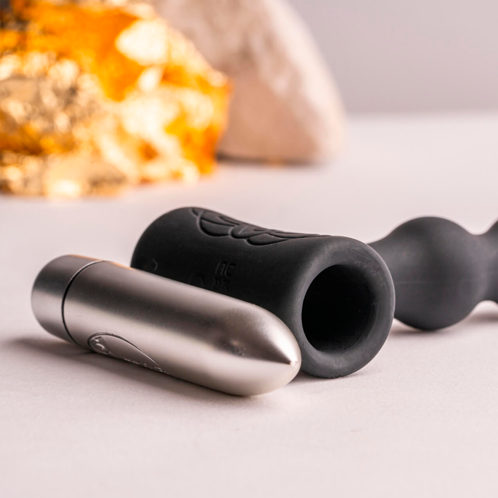 Black vibrating anal toy with controller and silver handle