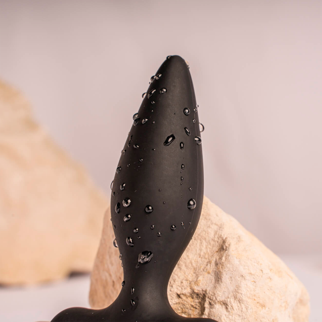 Black silicone anal plug with studded texture and narrow tapered tip