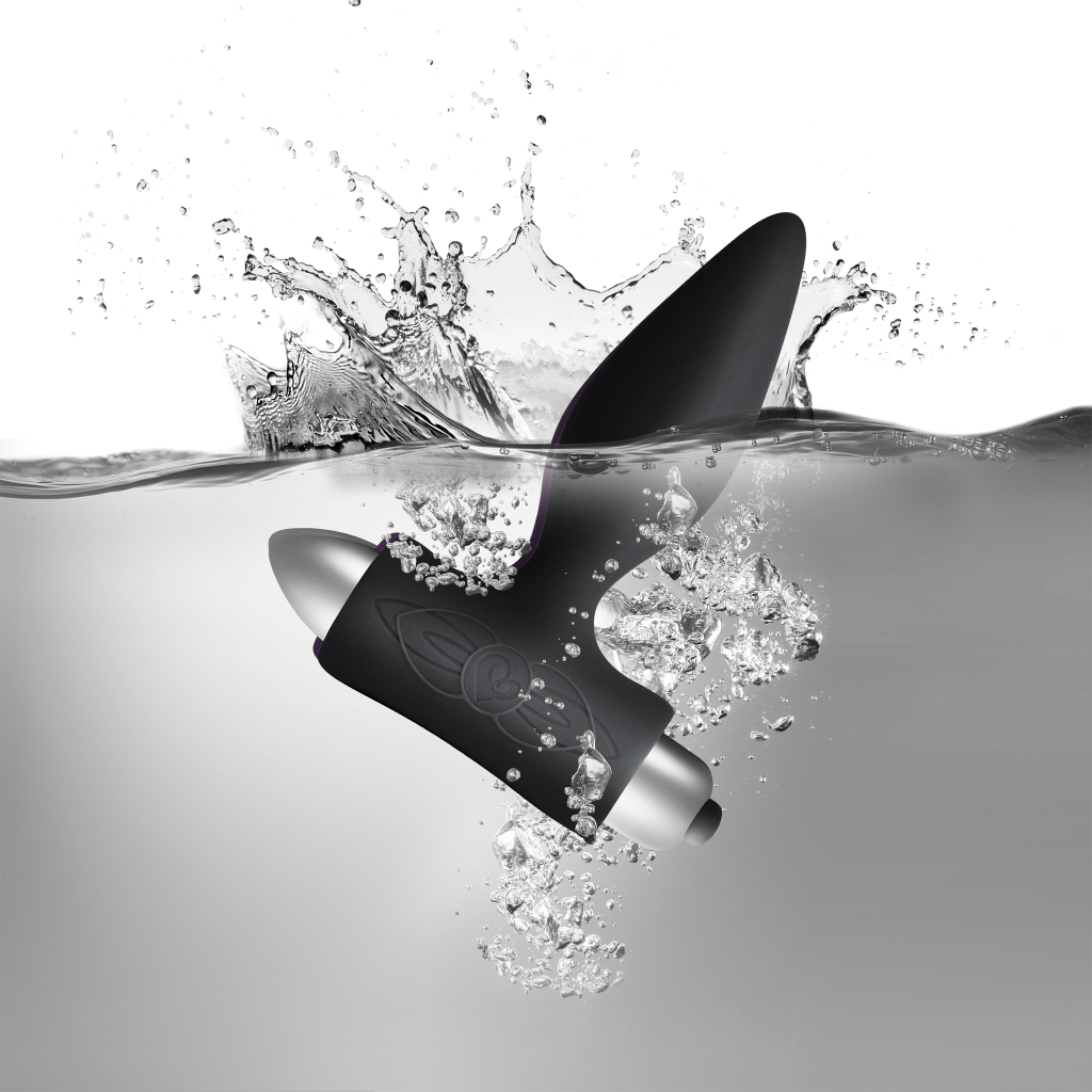 Black silicone vibrating anal plug with water droplets and sculpted floral emblem