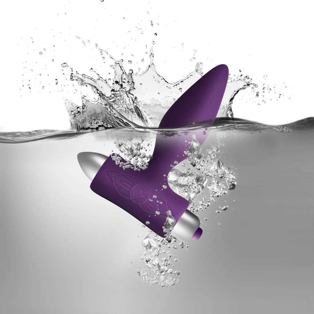 Purple silicone vibrating anal plug with water droplets and sculpted floral emblem