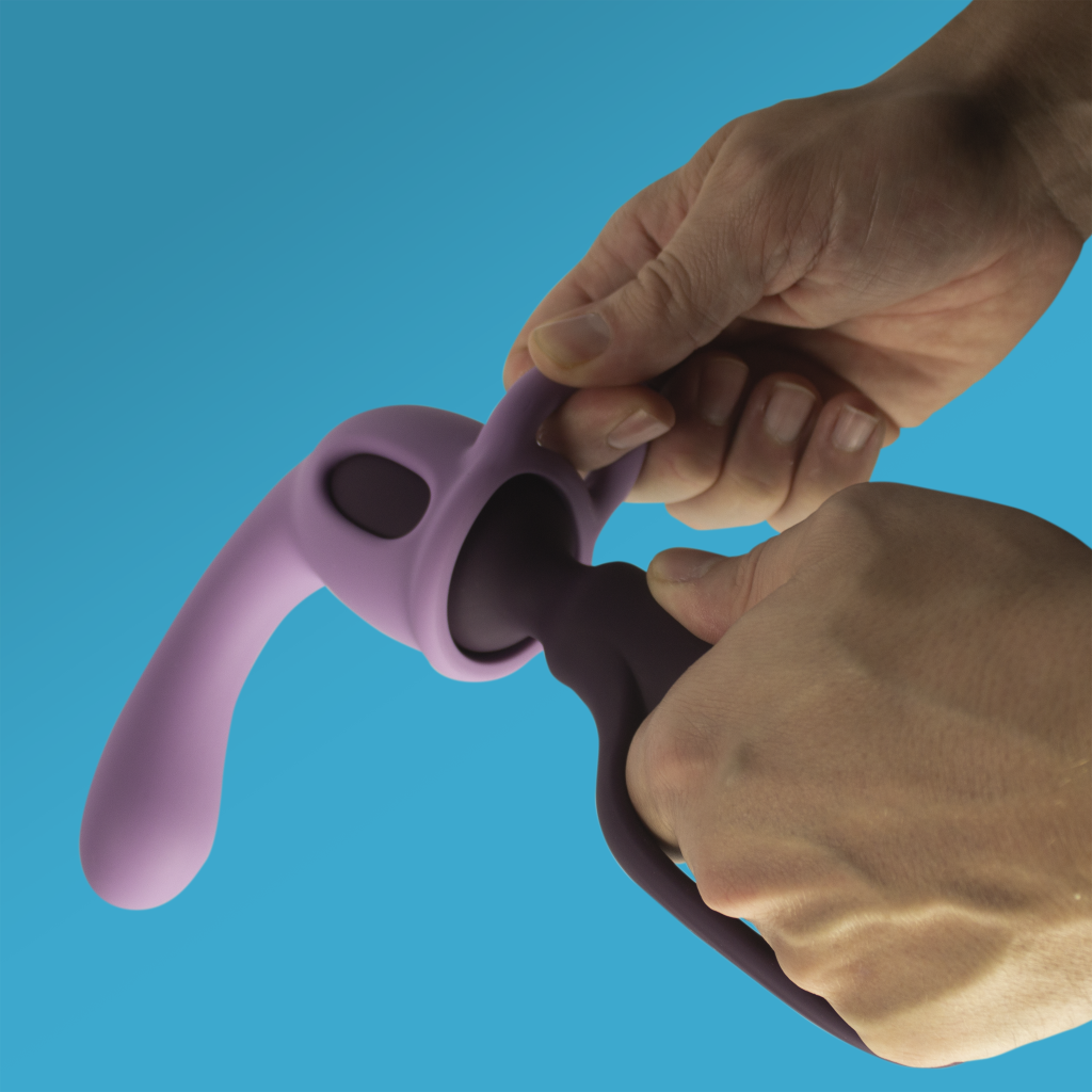 Light and dark purple silicone massager attachments being connected by hands