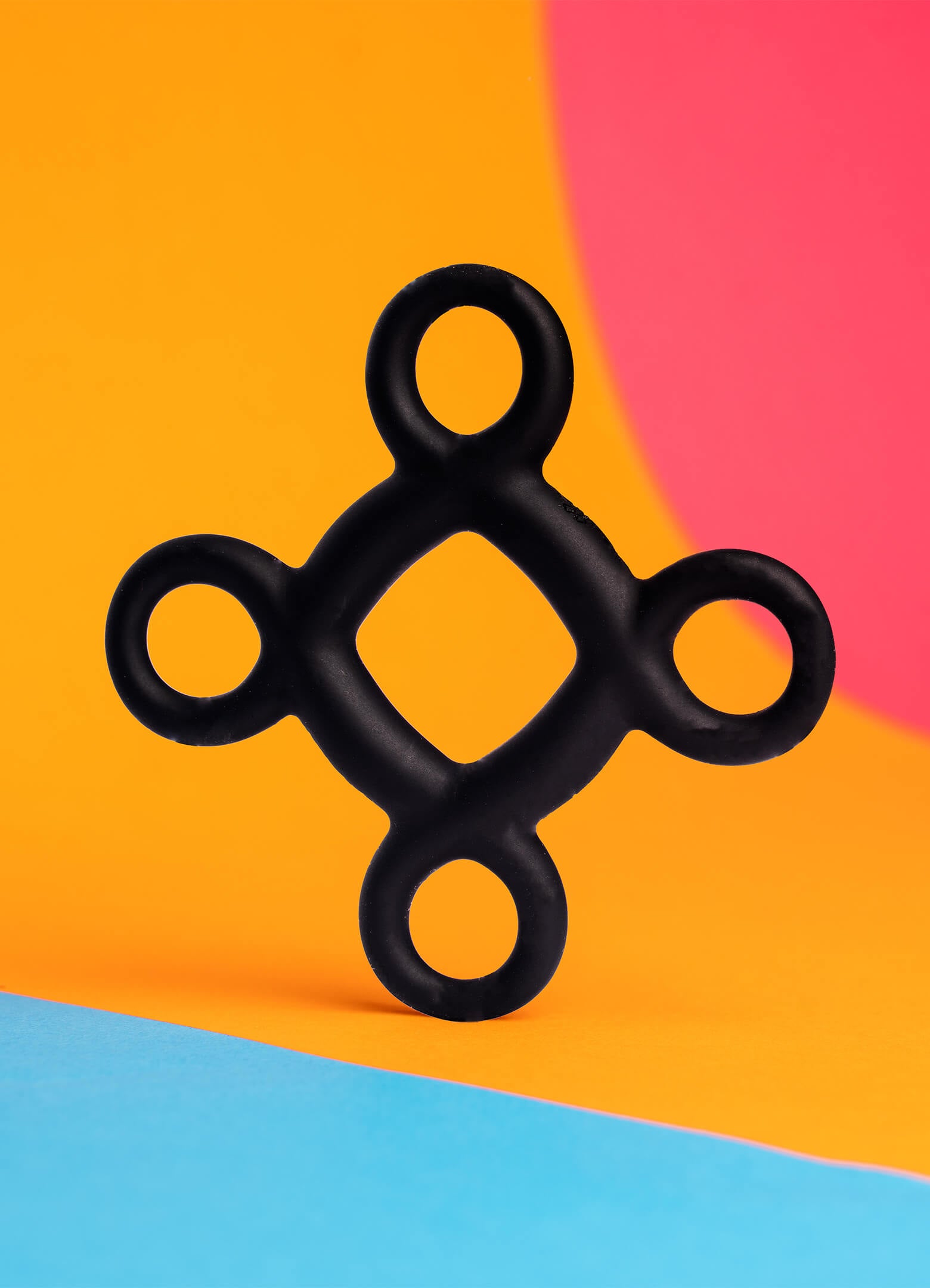 Black silicone cock ring with four accessible ring pulls to aid with application.