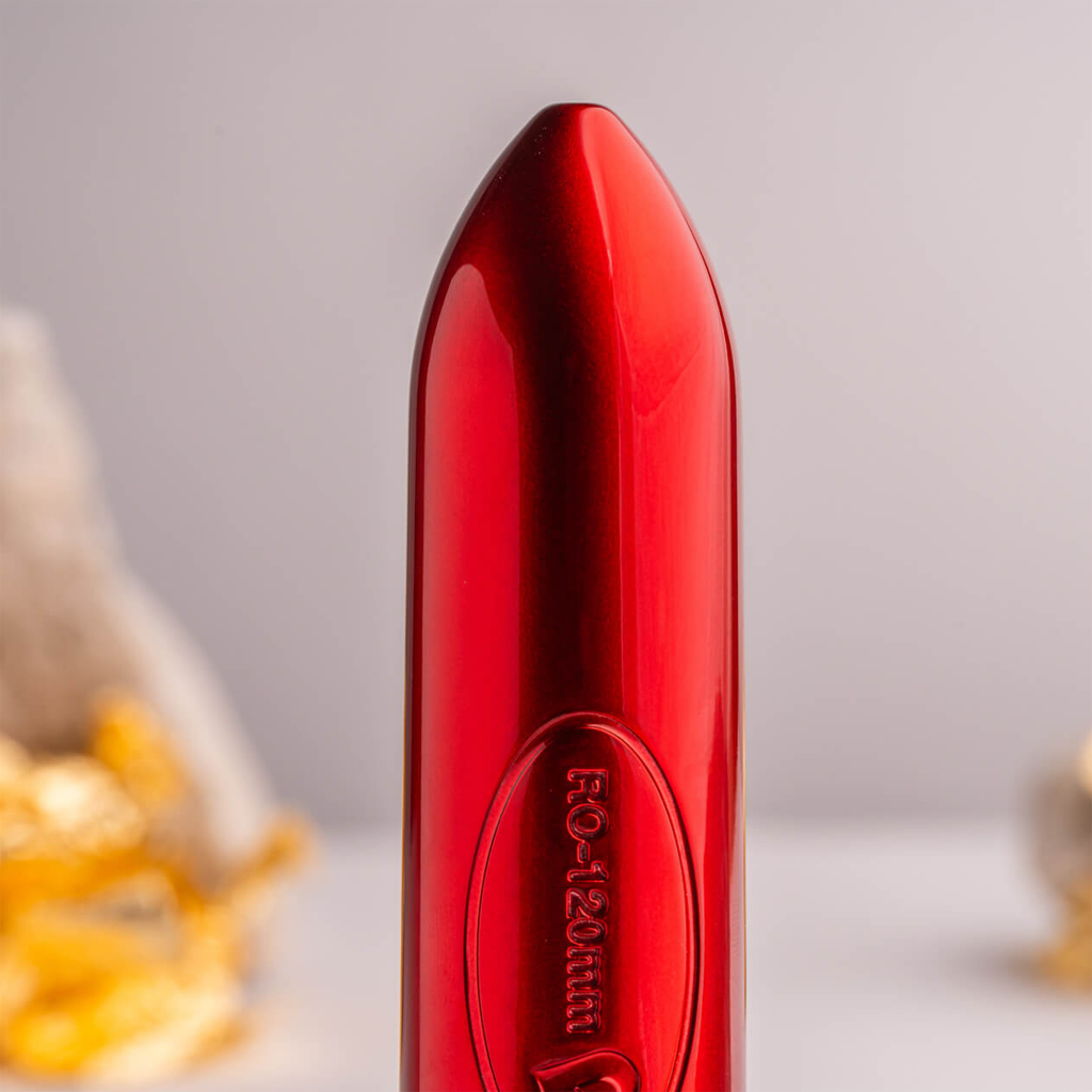 Red bullet-shaped device with embossed side label and glossy metal finish