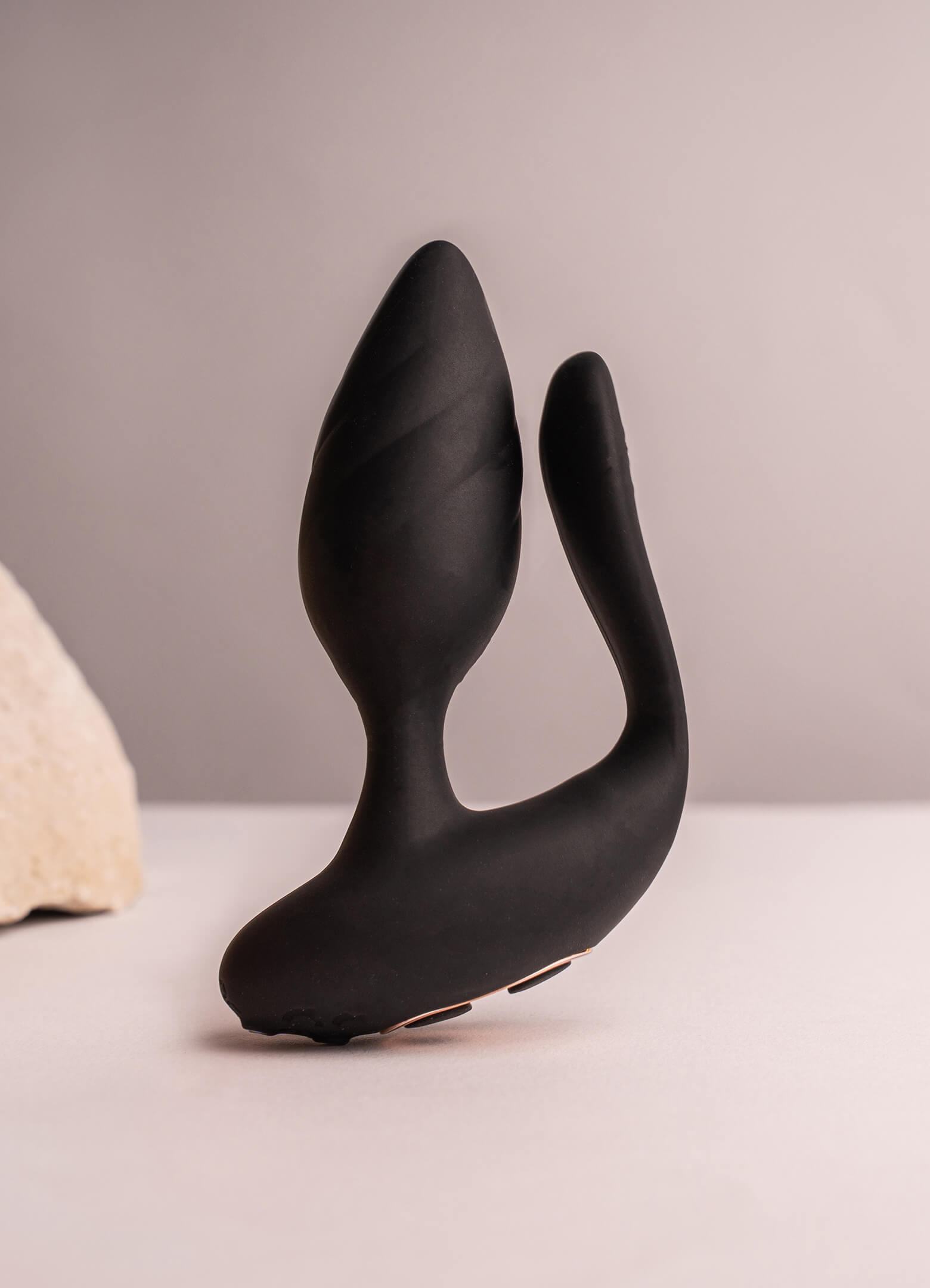 Black silicone butt plug with an insertable vaginal tail.