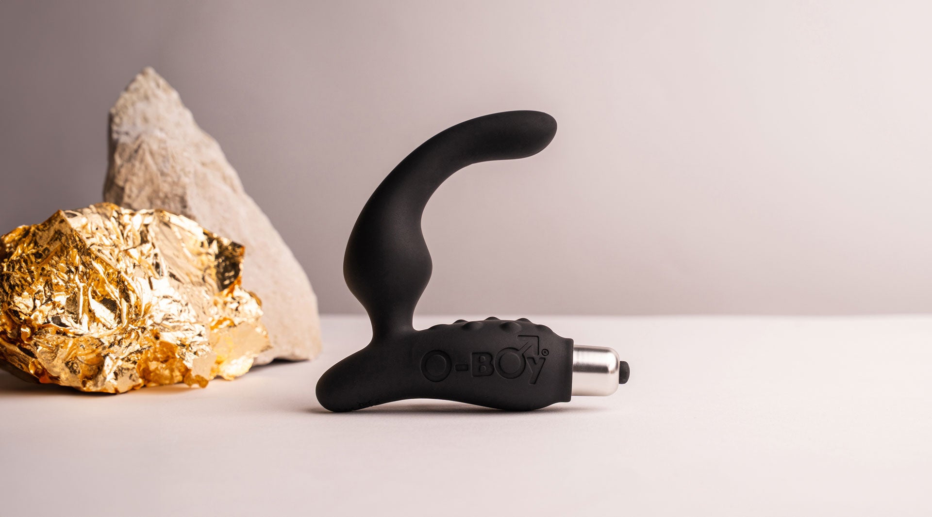 Silicone vibrating prostate massager with perineum pleasure points in black housing a removable bullet vibrator.