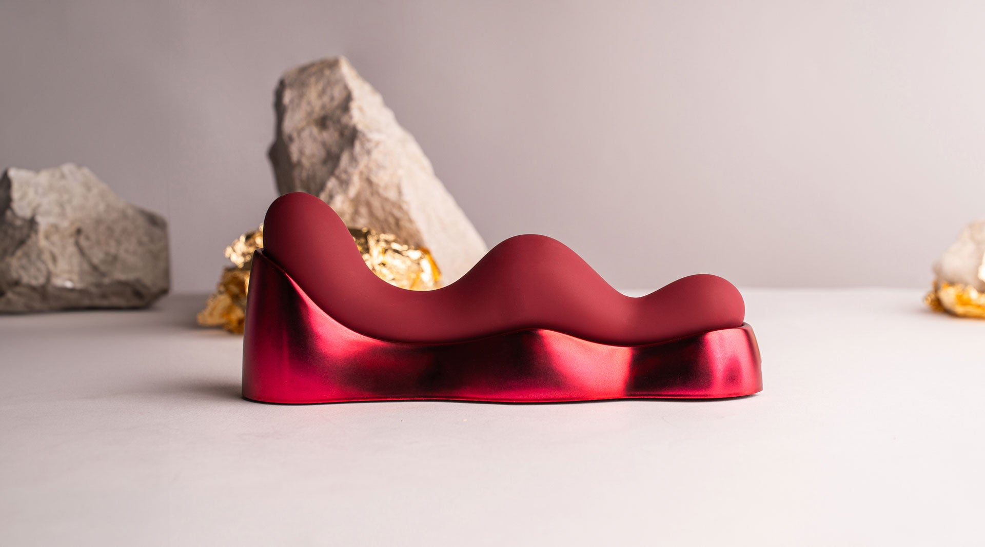 Silicone sit on grind on G-spot vibrator with charging unit in red.