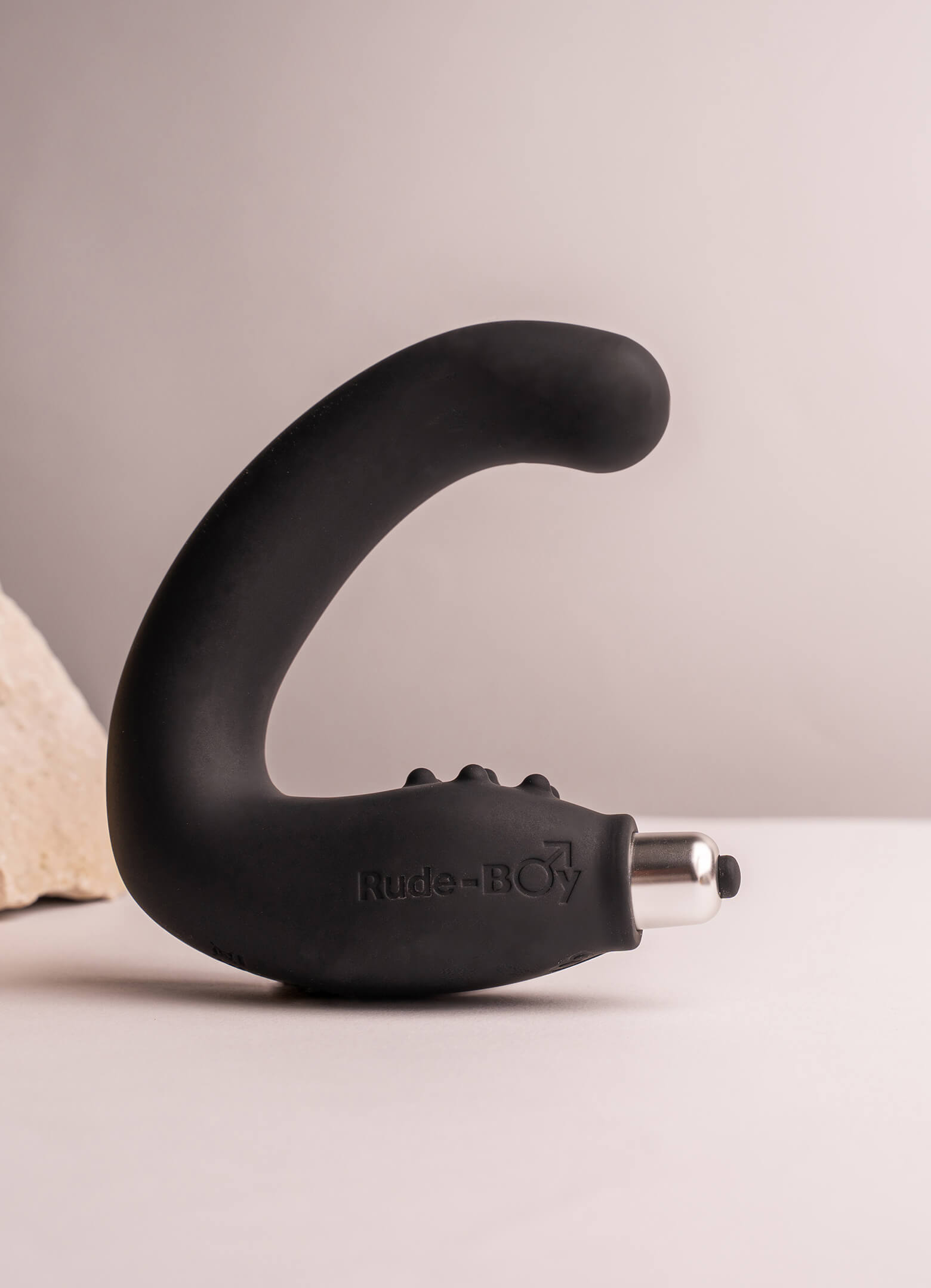 Silicone prostate massager with perineum stimulation points in black housing a removable bullet vibrator.