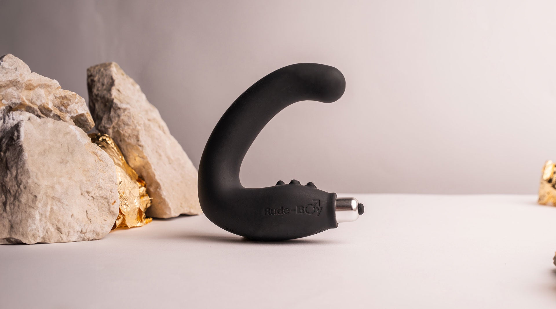 Silicone prostate massager with perineum stimulation points in black housing a removable bullet vibrator.