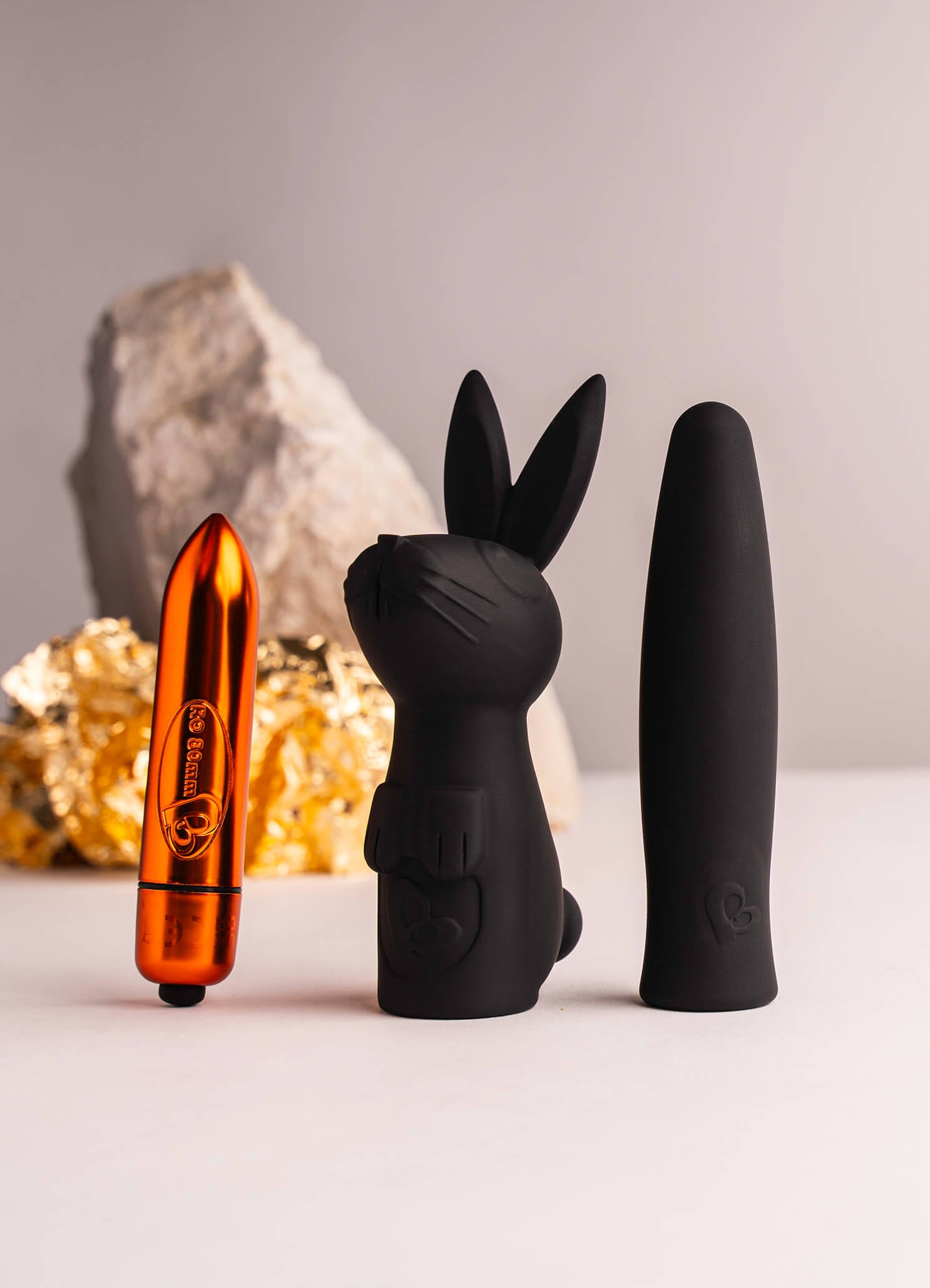 Orange bullet vibrator with a rabbit and finger sleeve set.