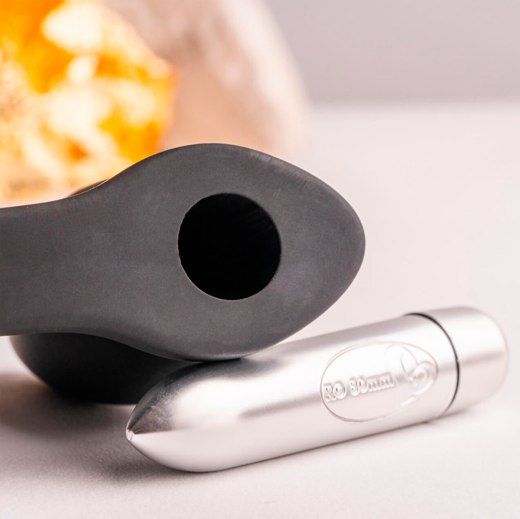 Black silicone base with oval opening and small side bumps, plus metallic tip