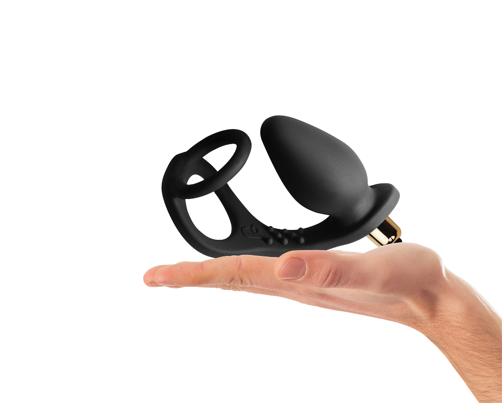 Black silicone pleasure device in hand; curved ring base, flared tip, and metallic end
