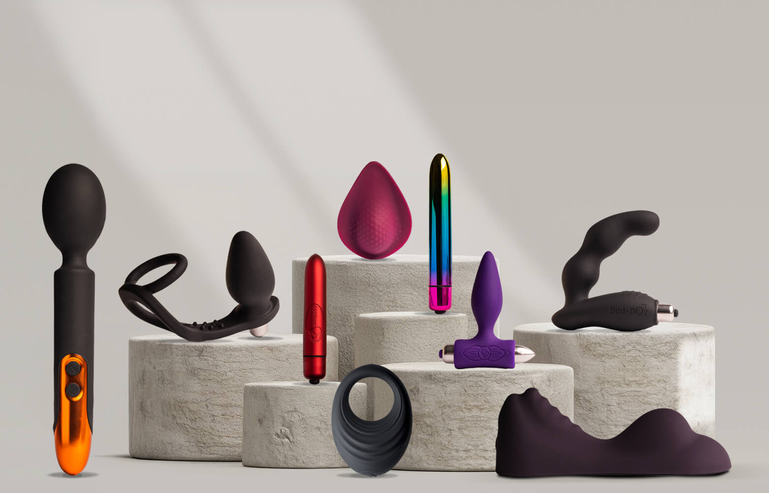 Collection of rocks-off products on a stone podium including vibrators and c-rings