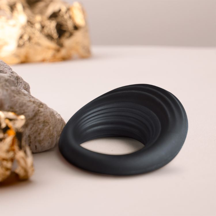 Black silicone cock ring, side view with inner opening