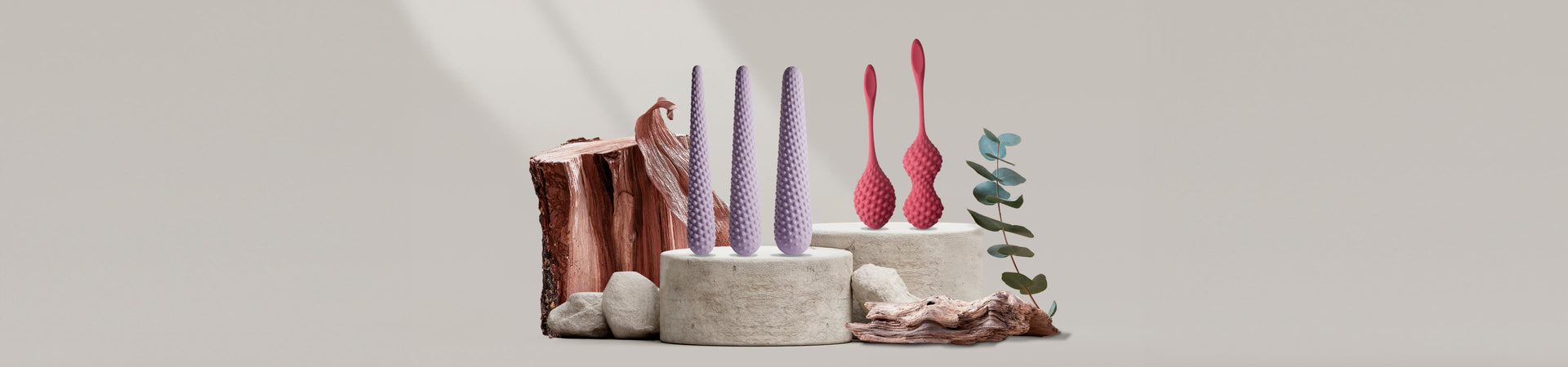 Collection of unite products on a stone podium including dilators and kegals