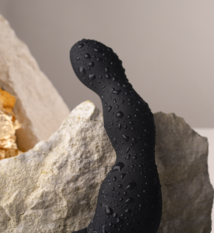 Black silicone massager tip with water droplets and textured surface for grip