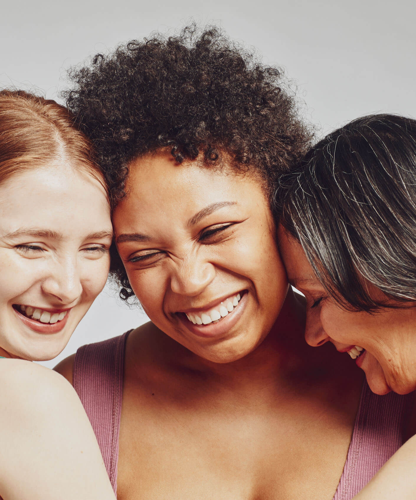 group of ladies, placing heads together, smiling