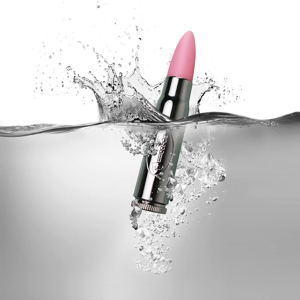 Silver soft tip Bullet Vibrator with pink tip half submerged in water