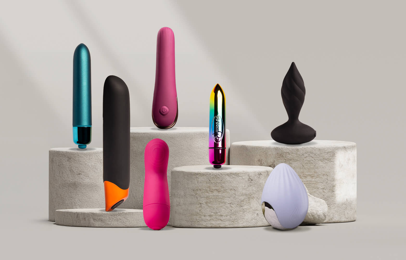 Collection of various vibrating products on a stone podium including classic vibrators