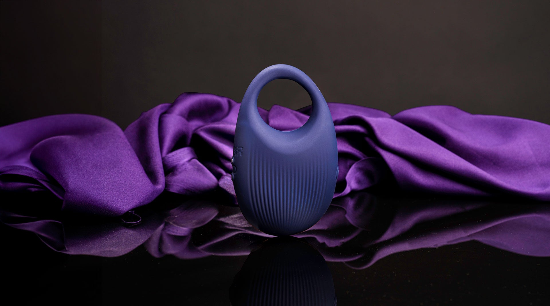 Vibrating navy silicone cock ring with a ribbed surface.