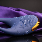 Navy blue ribbed silicone wearable device with raised nubs, gold edge, water droplets