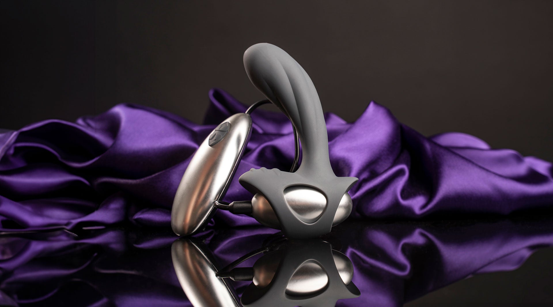 Remote controlled grey prostate vibrator with a rippled perineum pleasure point.