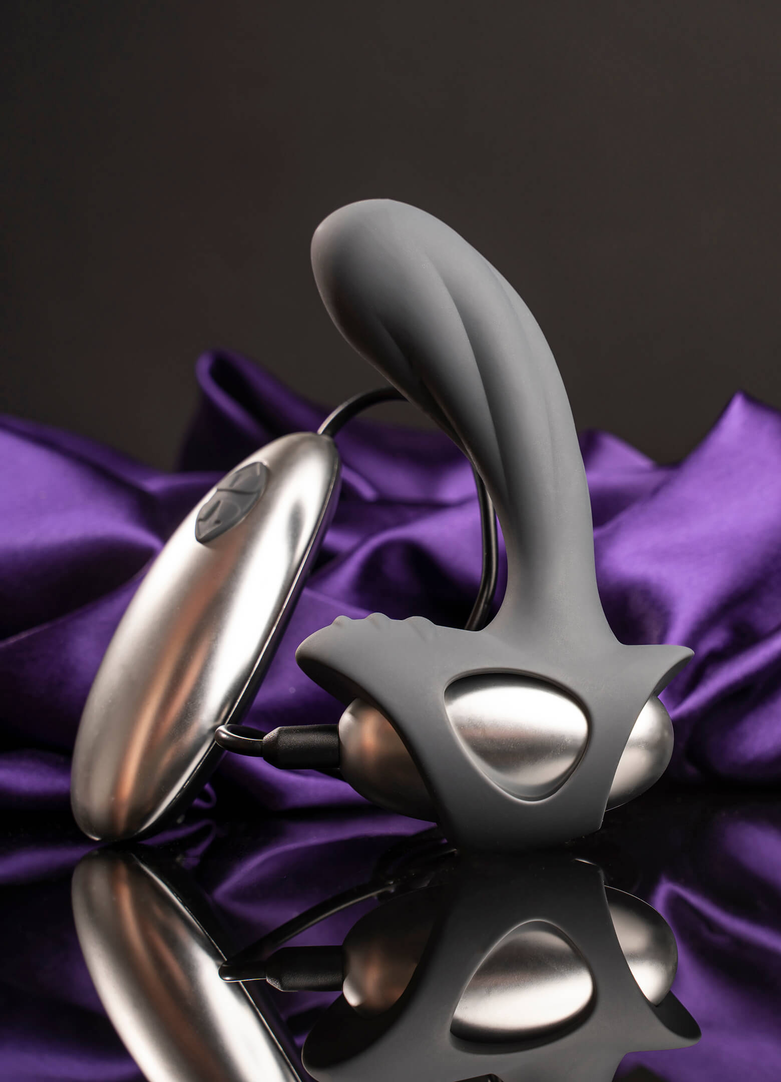 Remote controlled grey prostate vibrator with a rippled perineum pleasure point.