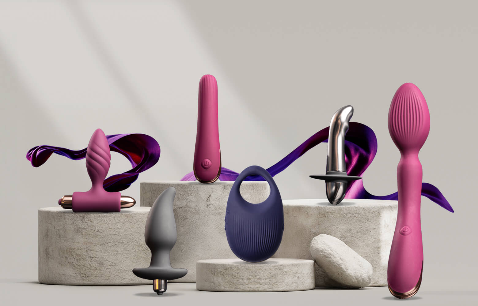 Collection of climaximum products on a stone podium including protate toys, wand and vibrator