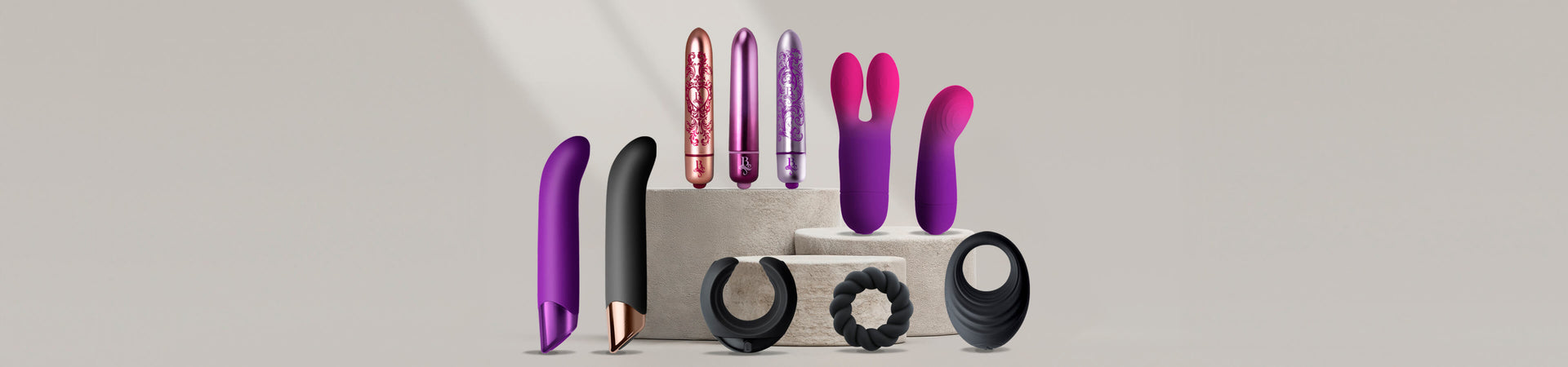 Collection of products including G-Spots, Bullets and masturbator on a grey podium