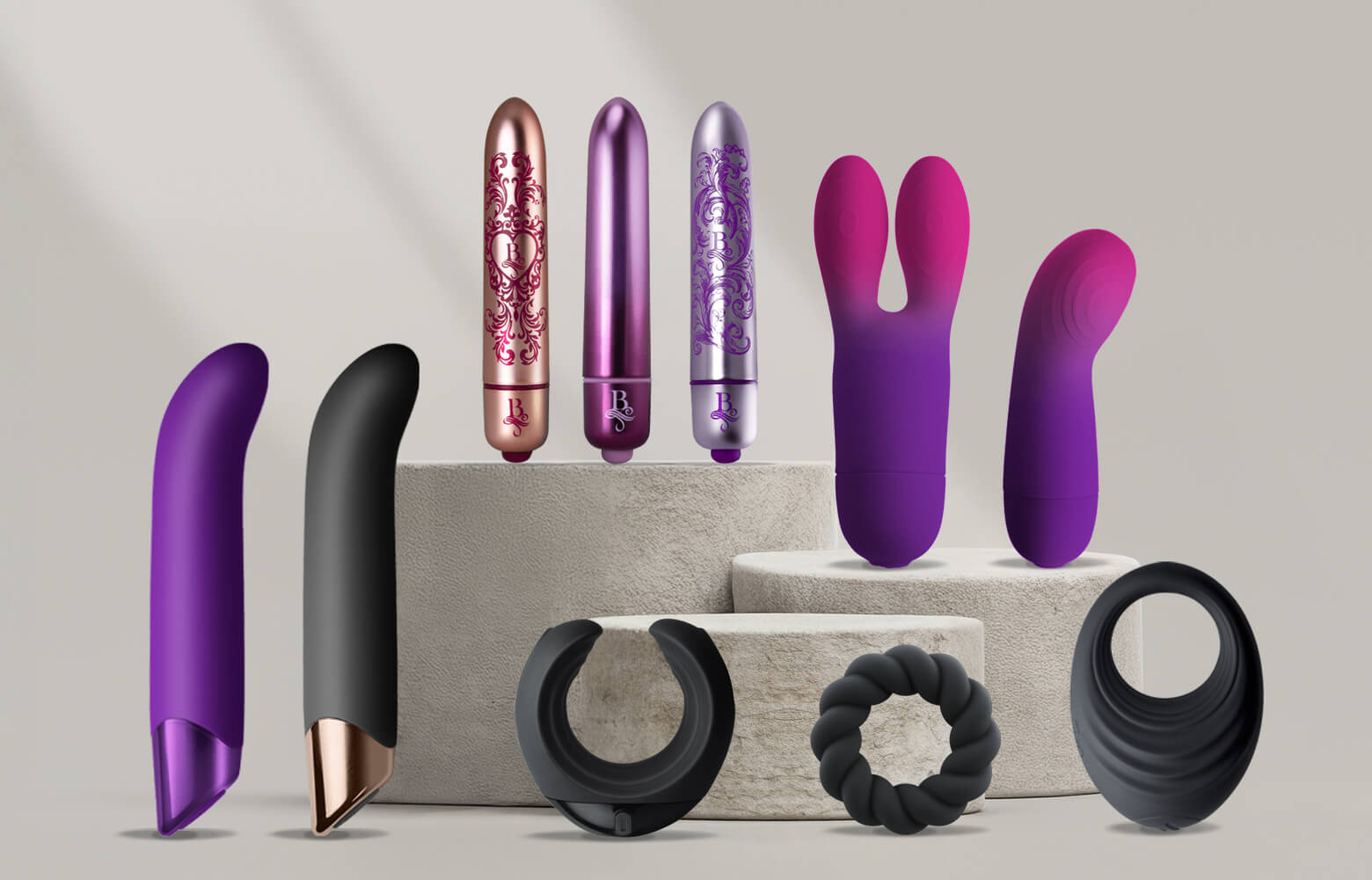 Collection of products including G-Spots, Bullets and C-Rings on a grey podium