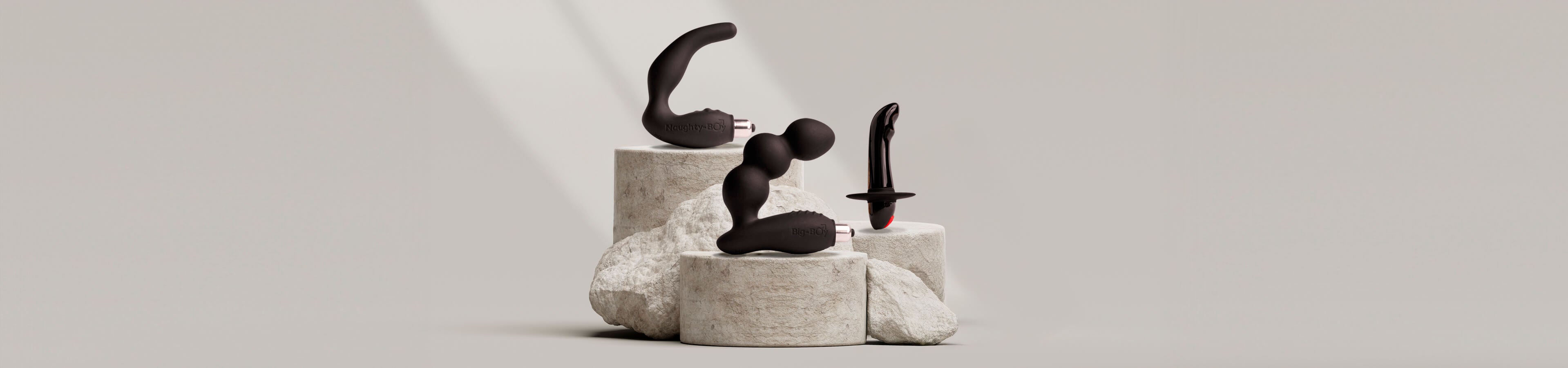 Prostate anal toys on a grey carved rock podium