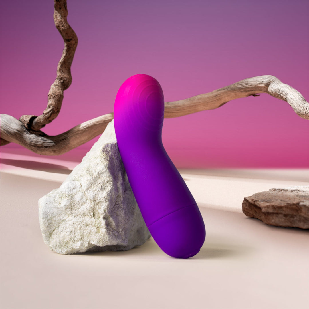 Purple and pink Glo-Girl Vibe on a rock with a pink background. Lightly textured  g-spot head