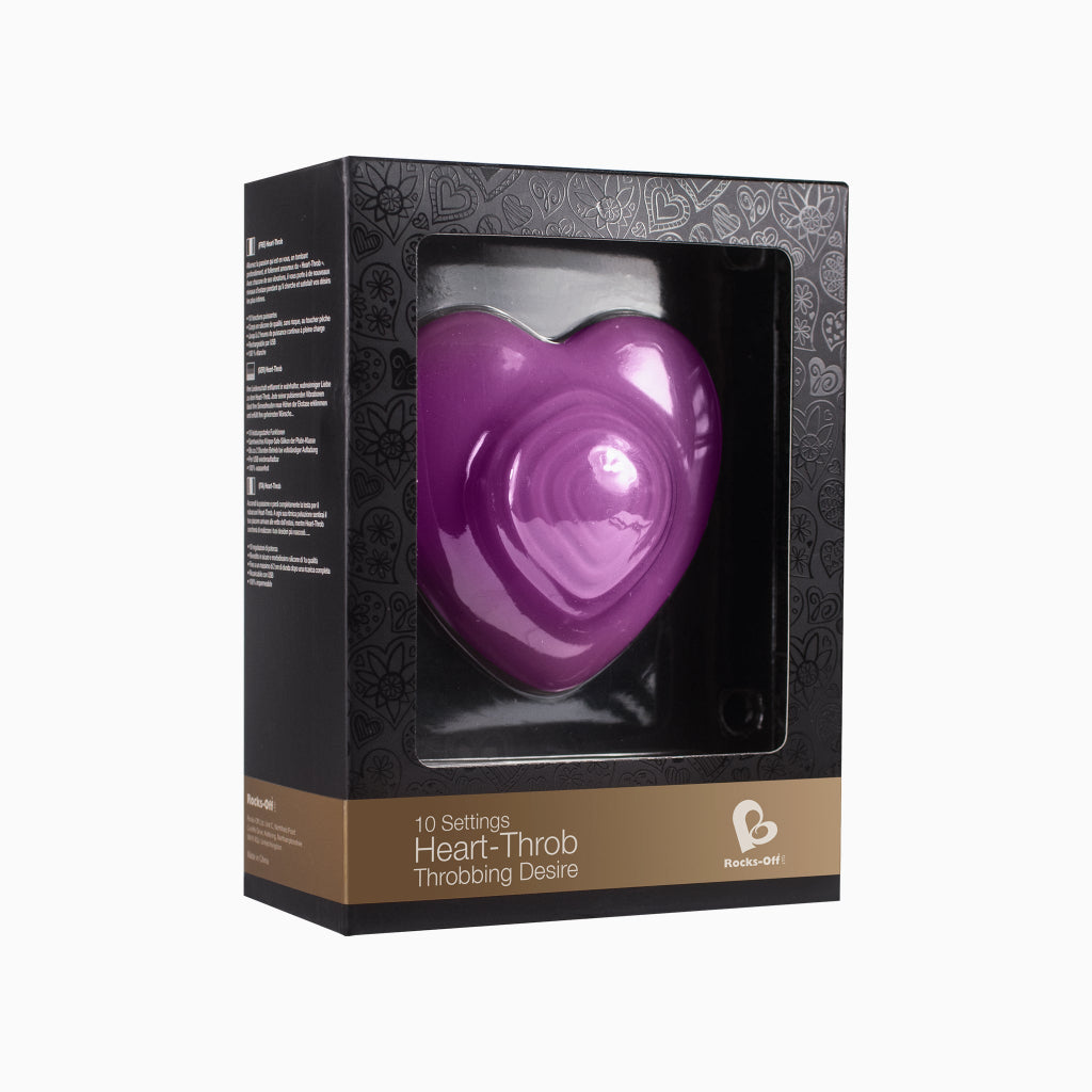 Purple heart-shaped massage toy in retail box with heart-shaped window