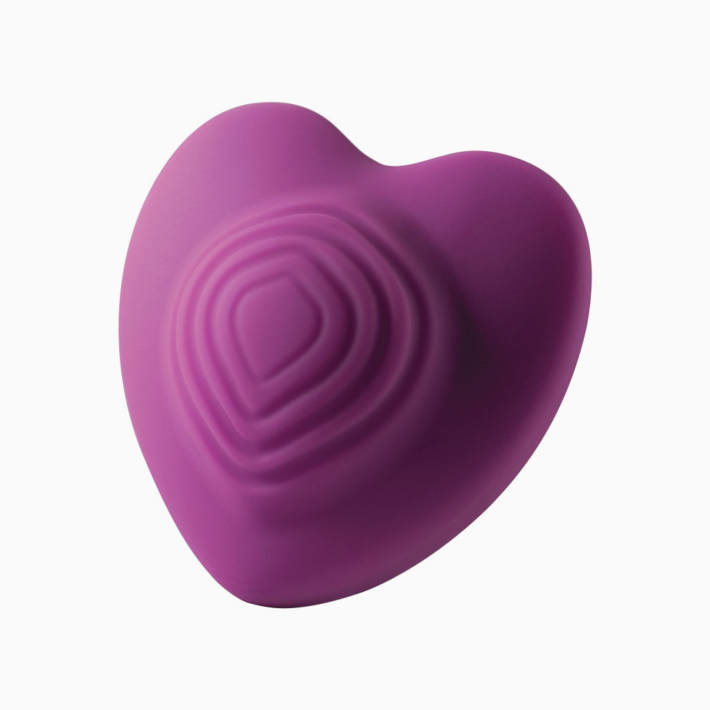 Purple heart-shaped silicone massage toy with raised swirl heart texture
