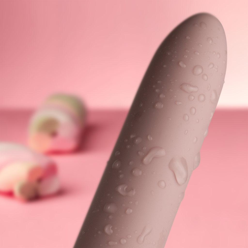 SugarBoo bullet vibrator, pink with textured, water-droplet style surface.