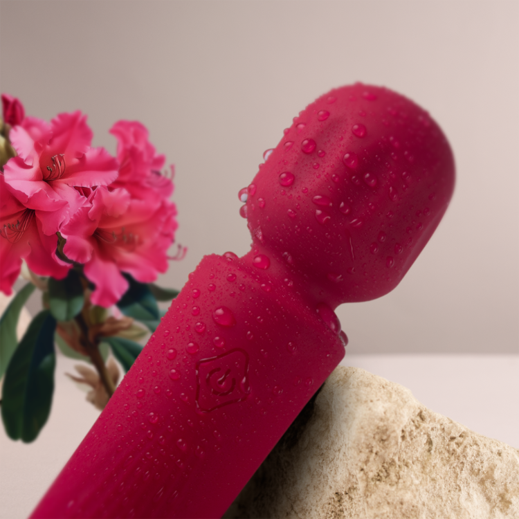 Red waterproof mini wand vibrator close-up with water droplets