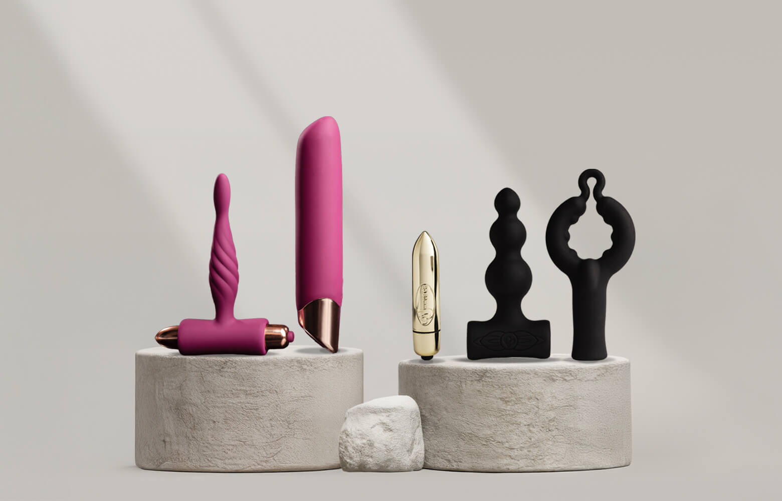 Collection of sex toy kits a stone podium including a vibrators, bullets and c-ring