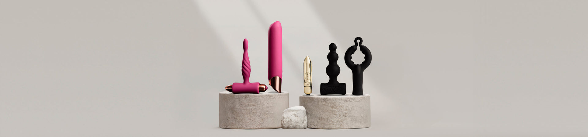 Collection of sex toy kits a stone podium including a vibrators, bullets and anal toy