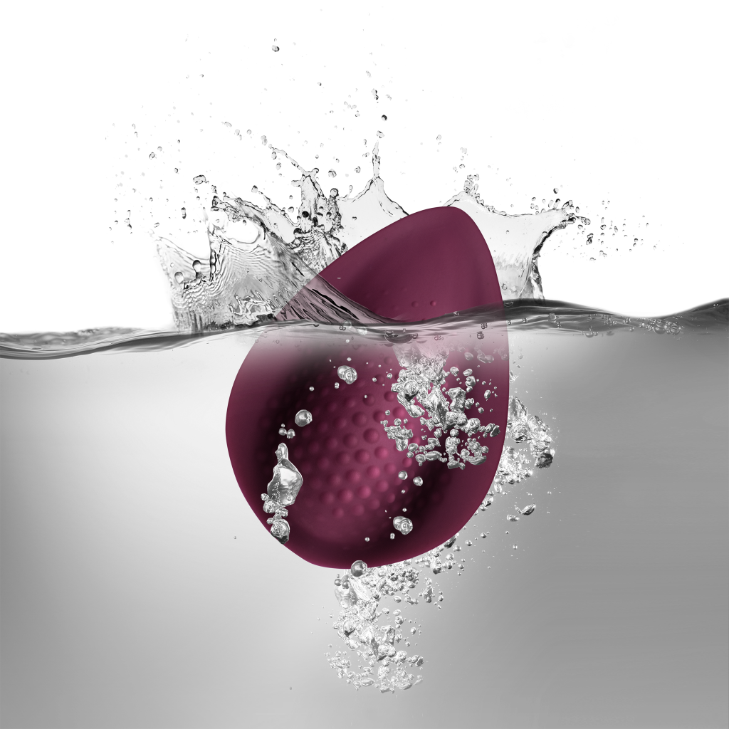 Maroon teardrop silicone massager with water splash and droplets