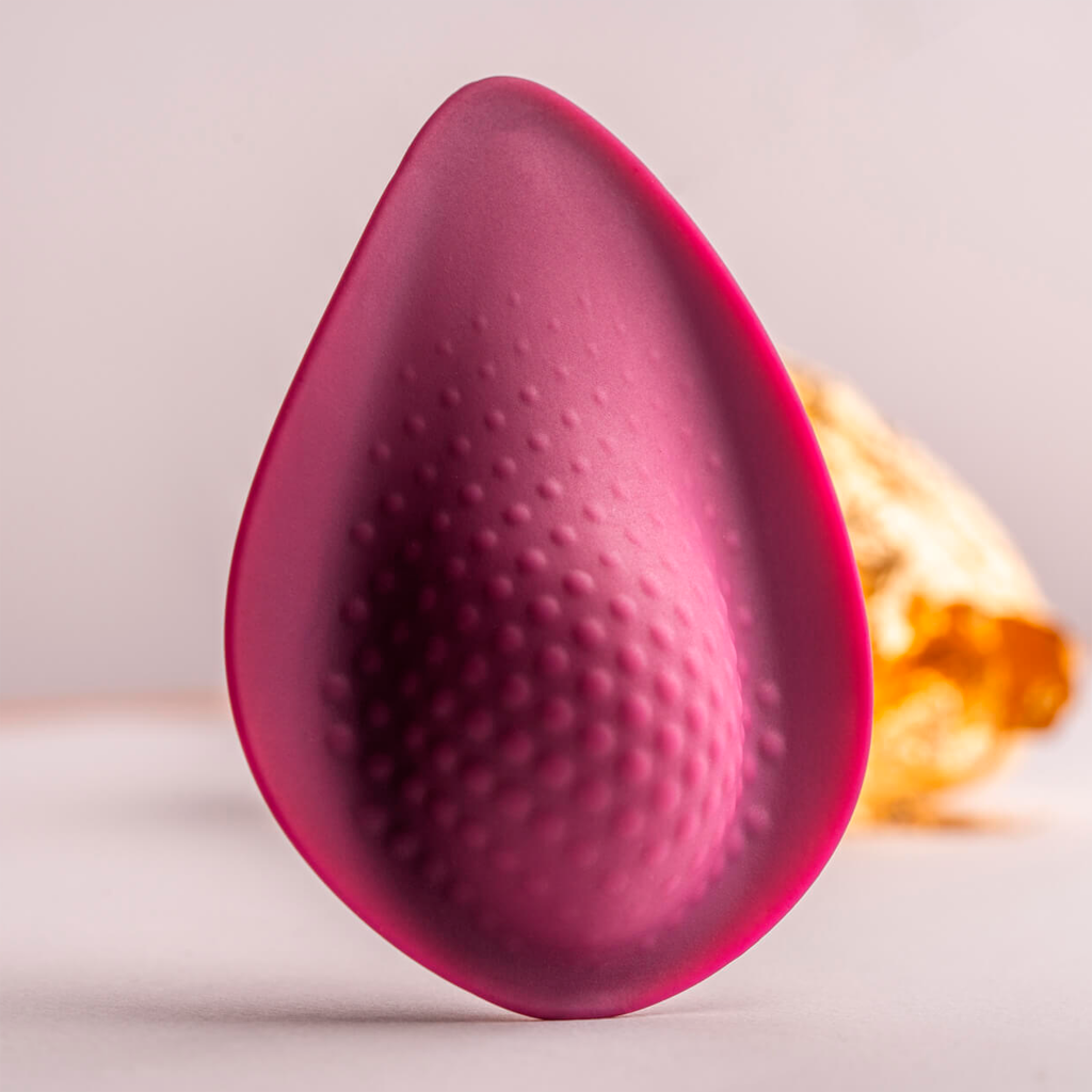 Maroon teardrop silicone massager with raised bubble texture