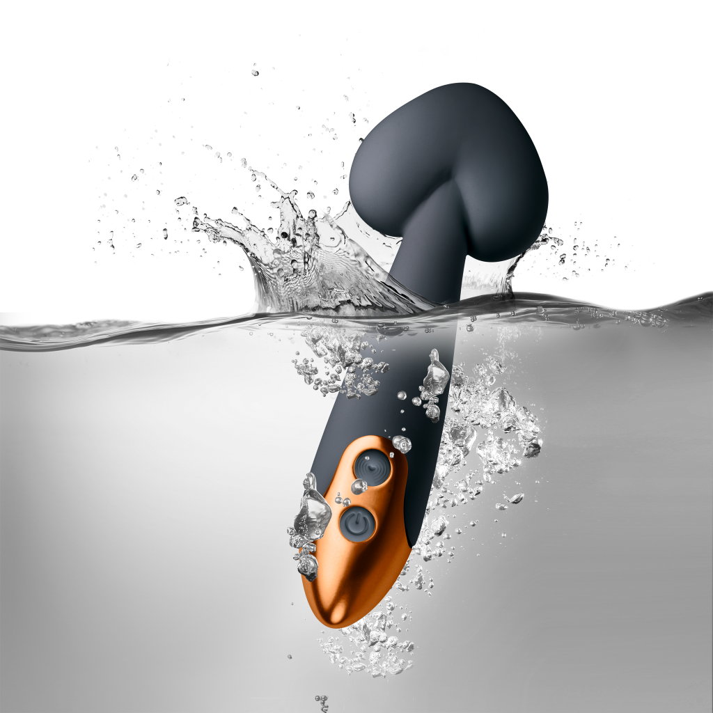 Black wand massager with orange handle controls, splashing water droplets around