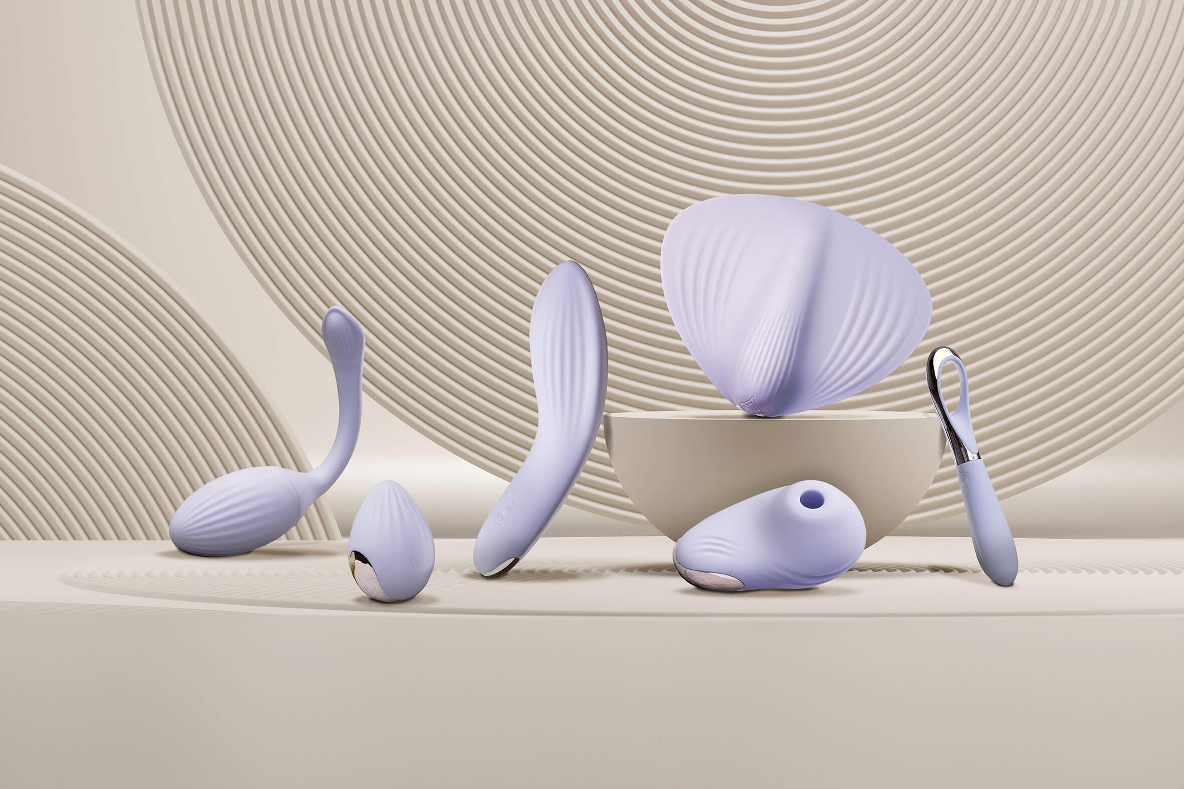 Featured collection of Niya Products set against calming sand circles including massagers, kegals, clit stilmulators